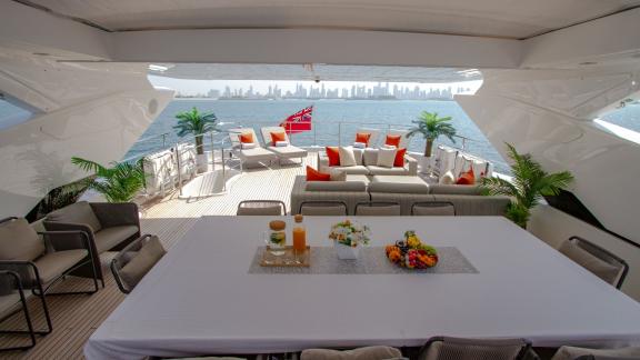 The dining area of the Legende motor yacht offers an unforgettable yacht rental experience with views of Dubai.