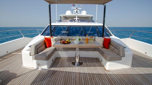 The seating area on the deck of the Legende motor yacht makes your Dubai yacht rental experience unforgettable.