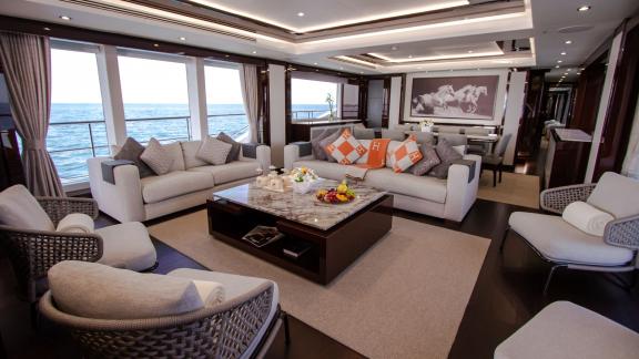 The salon of the Legende motor yacht offers a luxurious and cozy atmosphere for a Dubai yacht rental experience.