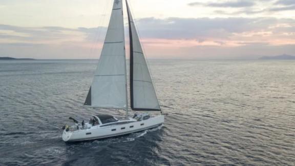 The Life Time sailing yacht enjoys a pleasant cruise at sunset on the open sea.