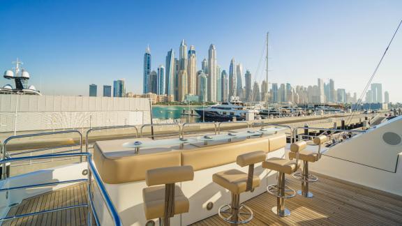 The bar on Lucien motor yacht's upper deck makes your Dubai yacht rental experience unforgettable.