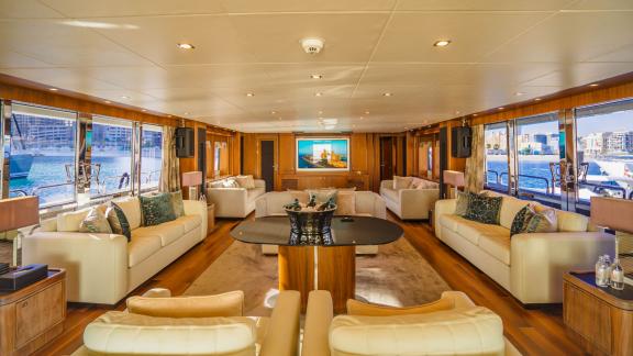 The spacious salon of Lucien motor yacht offers luxury and comfort for your Dubai yacht rental experience.