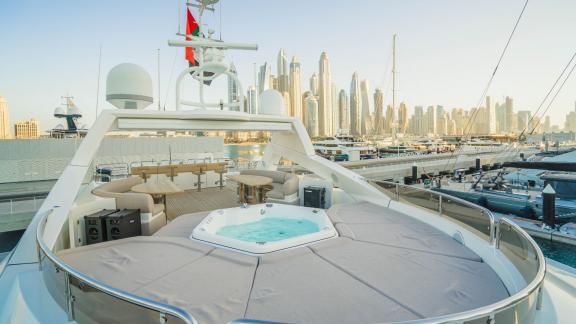 The upper deck of the Lucien motor yacht with a jacuzzi offers a unique space for luxury yacht rentals in Dubai.