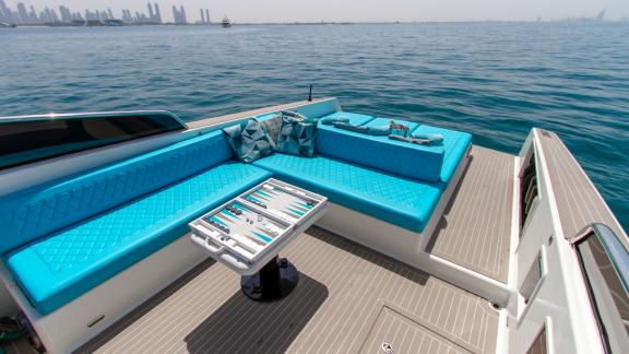 Comfortable seating area with blue cushions on the Lucky Me yacht, perfect for Dubai yacht rental.