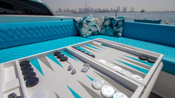 Enhance your Dubai yacht rental on Lucky Me with a fun backgammon game overlooking the serene sea view.