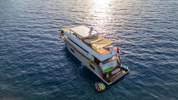 The luxury trawler Lycian Dream anchored at sea in Fethiye, surrounded by water toys.