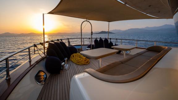 The sun deck of the luxury trawler Lycian Dream in Fethiye offers a serene sunset view.