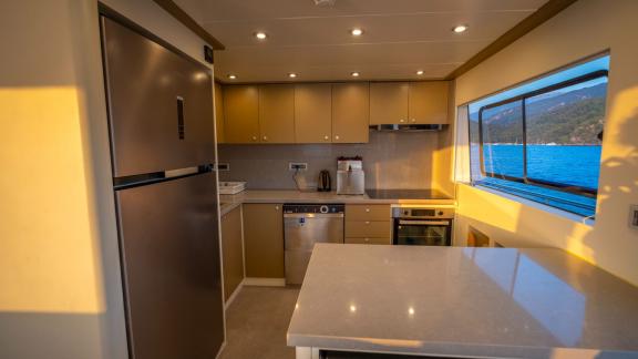 The modern kitchen of the luxury trawler Lycian Dream in Fethiye is fully equipped and stylishly designed.