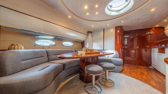 The salon of the yacht Make My Day features a stylish seating area and dining table, creating a spacious atmosphere.