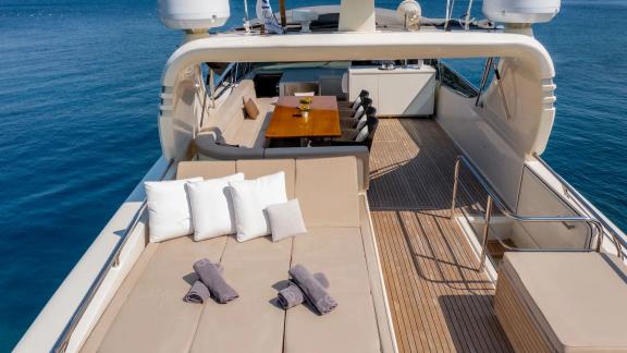 The upper deck of Miraval yacht features a comfortable sunbathing area and dining table.