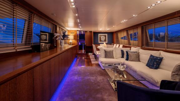 The modern salon on yacht Miraval features comfortable seating areas and stylish lighting.