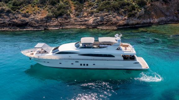 Luxury yacht Miraval in turquoise waters, side profile near the coast.