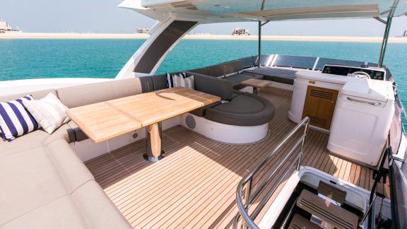 The upper deck of My Serenity features a dining area and comfortable seating for relaxation.