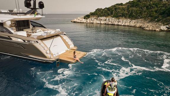 The Myne motor yacht impresses with sleek design and luxury styling at a serene cove.