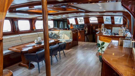 luxurious interior of a motor sailer with 5 cabins in Fethiye, including dining area and cosy lounge.