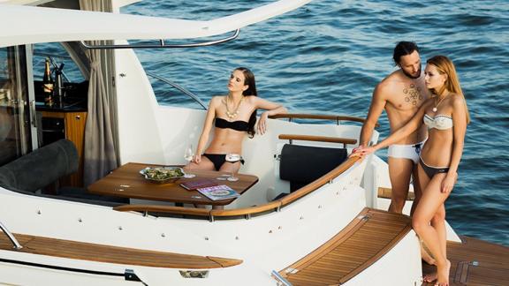 People sunbathing and enjoying the view on the aft deck of motor yacht North Star.