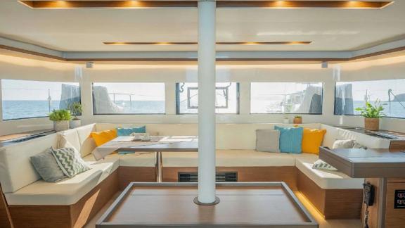 The spacious seating area inside the Oneida 2 catamaran provides a comfortable setting with a sea view.