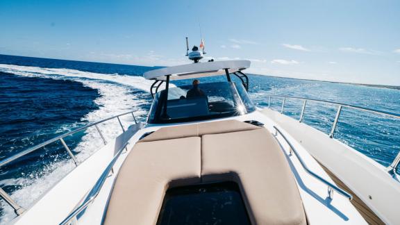 The front deck of the Orix motor yacht cruising swiftly through open waters.