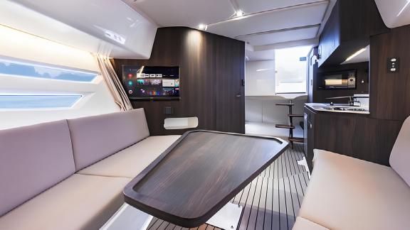 The Orix motor yacht features a modern interior with a seating area and advanced technological amenities for comfort.