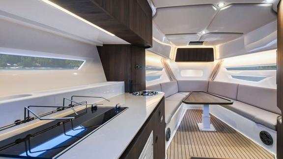 The elegant interior of the Orix motor yacht offers a spacious seating area and a modern kitchen for a comfortable exper