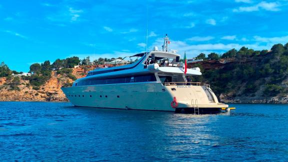 Paula 3 motor yacht is anchored in a calm bay.