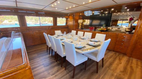 Paula 3 yacht offers an elegant dining table with beautiful sea views for a delightful meal experience.