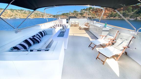 The upper deck of Paula 3 yacht features a seating area and comfortable chairs.