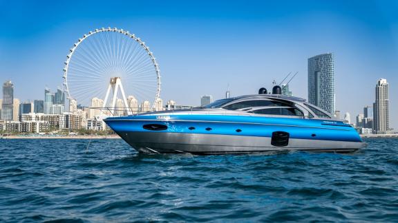 Pershing 70 combines style and power against Dubai's skyline, offering a luxurious yacht rental experience.