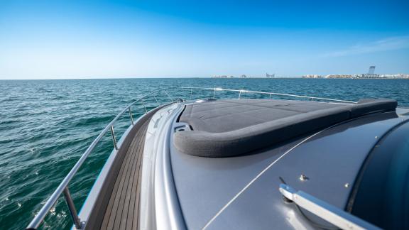 The spacious front deck of the Pershing 70 combines comfort and luxury for a perfect Dubai yacht rental experience.