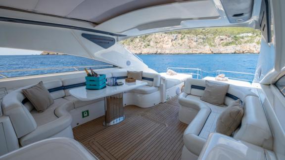 The dining table and U shaped seating areas of Princess Juliet are seen while cruising in Ibiza.