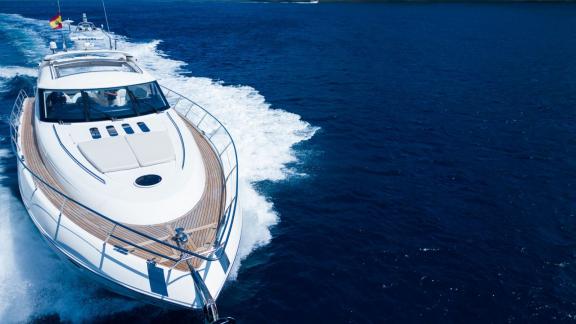 The spacious foredeck and teak walkways of Princess Juliet are seen while cruising off Ibiza.