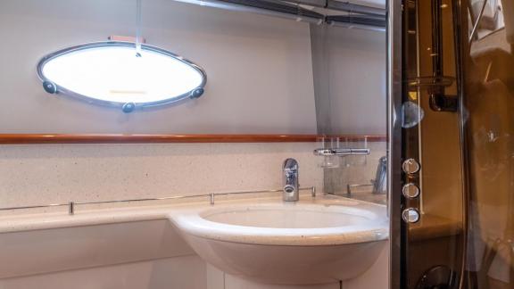 The modern bathroom of Princess Juliet features a sink, spacious countertop and enclosed shower cabin.