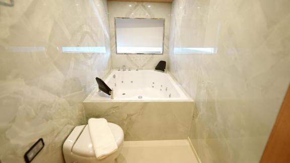 The bathroom on Princess Melda yacht offers a luxurious experience with its jacuzzi and stylish design.