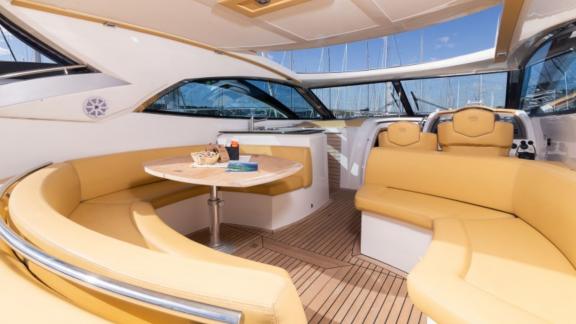 Comfortable seating arrangement and table on the deck of motor yacht Sabijac.