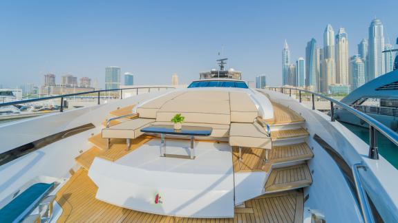 The front deck of the Saffuriya yacht features an elegant seating area and city views.