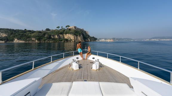 Enjoy the sea view from the foredeck of the Sandi IV motor yacht with a luxury yacht rental in Naples.