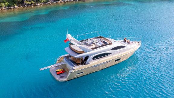 The motor yacht Selenge is peacefully anchored in turquoise waters.