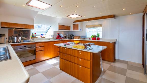 The fully equipped kitchen on the Shangra motor yacht enhances the comfort of your Olbia yacht charter experience.