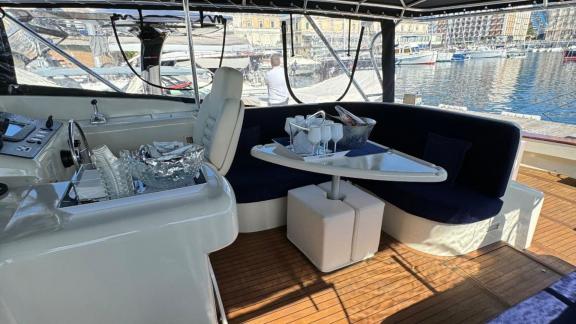 Rent a yacht in Naples for a day and enjoy the luxurious seating area of Skins while soaking in the Mediterranean atmosp