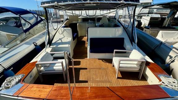 With a motor yacht rental in Naples, you can enjoy a comfortable experience and embrace the sea on Skins' wide aft deck.