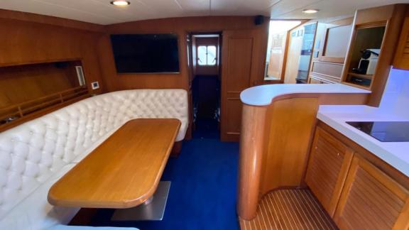 Rent a motor yacht in Naples and enjoy a luxurious dining experience in the stylish salon of Skins while cruising the se