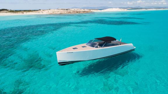 The Smart Ass motor yacht is seen from the front, floating in clear waters.