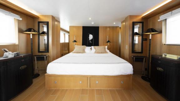 Among motor yacht rental options in Athens Sounion II master cabin with large bed and symmetric layout is seen.