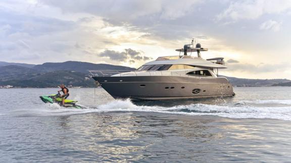 Stela 117 yacht with a jetski enjoying fun water activity at sea.