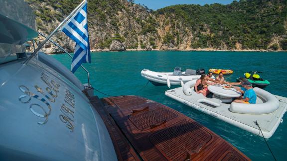 Guests enjoy the inflatable platform next to the Stela 117 yacht.