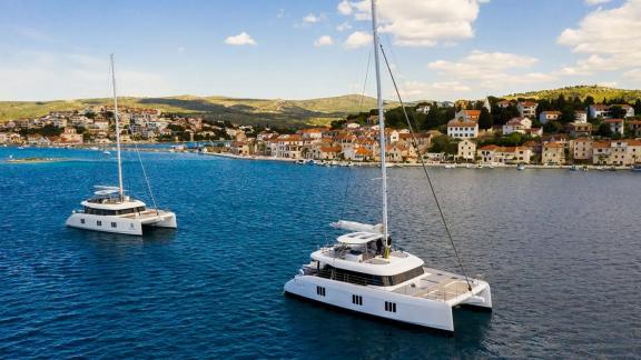 Sunreef 60 catamarans Mr. Si and Sinata stand out with their sleek silhouettes near the coast of Rogoznica.