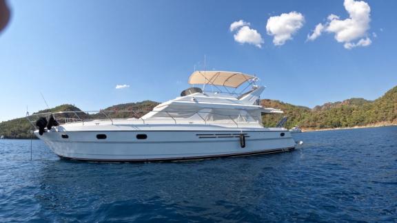 Motor yacht Sweet Lily anchored in a beautiful bay.