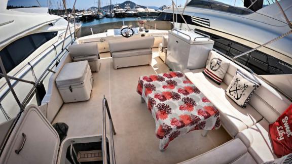 Upper deck of motor yacht Sweet Lily with a cozy seating area.