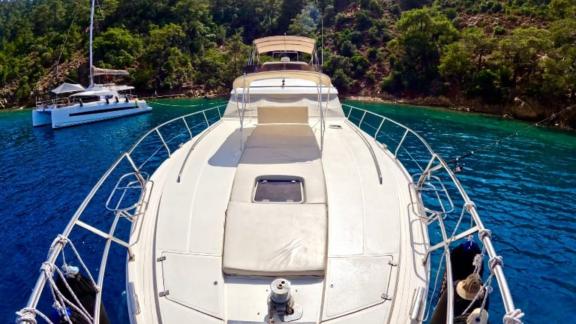 Foredeck of motor yacht Sweet Lily, anchored in a beautiful bay.