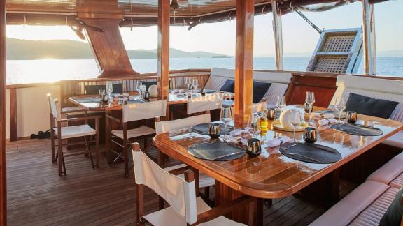 A beautifully laid table on the Gulet Cataleya, ready for a sunset dinner.